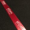 Dark red printed ribbon with white text