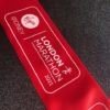 Red branded ribbon with white logo