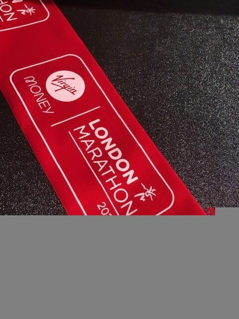 Red branded ribbon with white logo